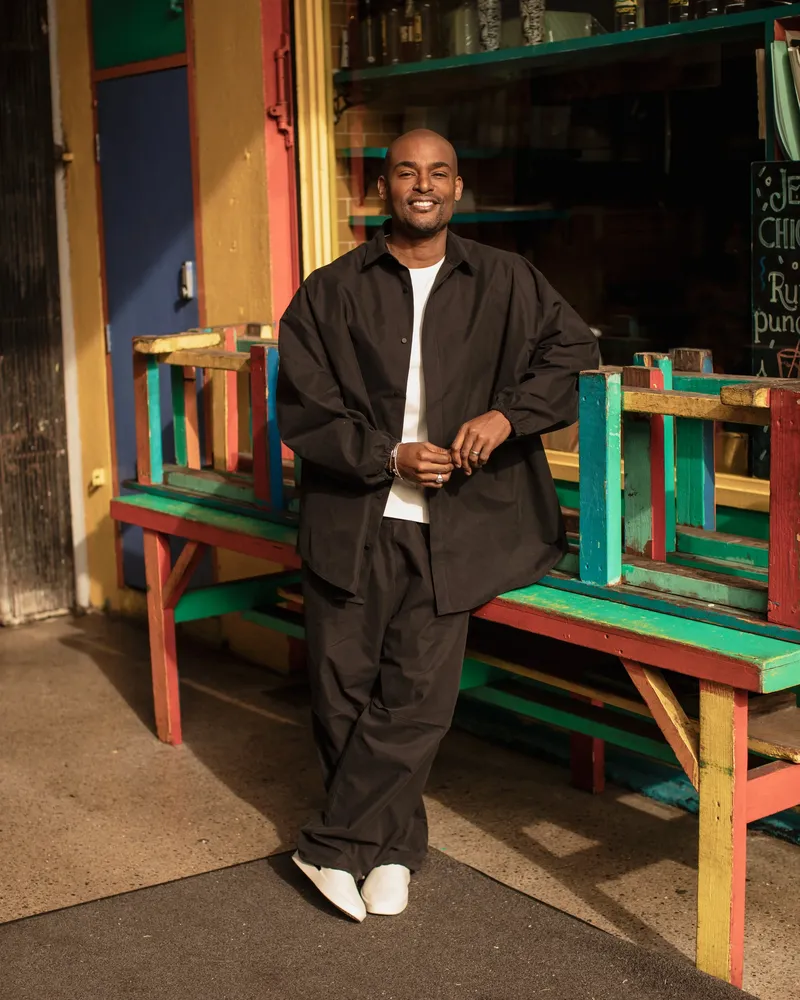 Paul C. Brunson, standing outside a cafe